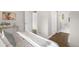 Comfortable bedroom with hardwood floors, neutral colors, and a glimpse into the bathroom at 1035 S Garfield St, Denver, CO 80209