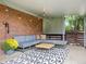 Inviting patio features brick, comfortable seating, string lights and patterned rug at 1035 S Garfield St, Denver, CO 80209