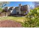 Backyard featuring lawn, a deck, fencing, and mature trees at 12743 Eudora Dr, Thornton, CO 80241