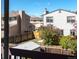 A fenced backyard, viewed from a balcony, shows a shared backyard and lilac bushes at 12743 Eudora Dr, Thornton, CO 80241