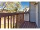 Balcony view with brown railings and a glimpse of the neighborhood's trees and building exteriors at 12743 Eudora Dr, Thornton, CO 80241