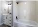 A modernized bathroom in white features a vanity, mirror, black hardware, and a tub shower at 12743 Eudora Dr, Thornton, CO 80241