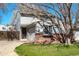 Charming two-story home featuring a well-maintained lawn, brick accents, and an attached garage, creating curb appeal at 12743 Eudora Dr, Thornton, CO 80241