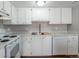 Bright, white kitchen with modern appliances, ample counter space, and updated fixtures at 12743 Eudora Dr, Thornton, CO 80241