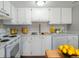 Bright, white kitchen with ample cabinet space, stainless steel sink, and modern appliances at 12743 Eudora Dr, Thornton, CO 80241