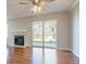 Living room featuring sliding glass doors to backyard, a fireplace, and laminate wood floors at 12743 Eudora Dr, Thornton, CO 80241