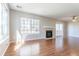 Bright living room featuring a fireplace, large windows providing plenty of natural light, and wood flooring at 12743 Eudora Dr, Thornton, CO 80241