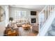 Inviting living room featuring a cozy fireplace, large window, and stylish furnishings at 12743 Eudora Dr, Thornton, CO 80241