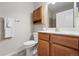Bathroom featuring a vanity, toilet, cabinet, and shower at 2360 Santa Fe Dr # B, Longmont, CO 80504