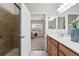 Bathroom with tile shower and direct view into the primary bedroom at 2360 Santa Fe Dr # B, Longmont, CO 80504