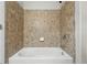 Bathroom tub and shower featuring updated tile at 2360 Santa Fe Dr # B, Longmont, CO 80504