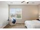 Relaxing bedroom featuring a ceiling fan, plush carpet and large window at 2360 Santa Fe Dr # B, Longmont, CO 80504