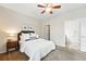 Comfortable bedroom featuring soft carpet, a ceiling fan and direct access to an ensuite bathroom at 2360 Santa Fe Dr # B, Longmont, CO 80504