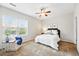 Cozy bedroom with large window allowing abundant natural light and soft neutral colors at 2360 Santa Fe Dr # B, Longmont, CO 80504