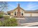 Charming single-story home featuring a stone chimney, attached garage, and well-manicured landscaping at 2360 Santa Fe Dr # B, Longmont, CO 80504