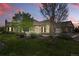Inviting exterior with manicured lawn, mature trees, and a charming facade at sunset at 2360 Santa Fe Dr # B, Longmont, CO 80504