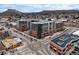 Aerial view showcasing the apartment complex in a vibrant city with convenient road access at 20 Wilcox St # 302, Castle Rock, CO 80104