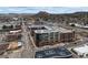 Aerial view showcasing the apartment complex with surrounding city and mountain views at 20 Wilcox St # 302, Castle Rock, CO 80104