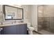 Bathroom featuring granite countertops, a large mirror, and a glass shower at 20 Wilcox St # 302, Castle Rock, CO 80104