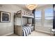Bedroom featuring rustic-style bunkbeds next to a bright window at 20 Wilcox St # 302, Castle Rock, CO 80104