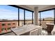 Bright dining area with large windows, a modern light fixture, and views of the city at 20 Wilcox St # 302, Castle Rock, CO 80104