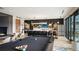 Game room with a pool table, kitchen, and bar seating perfect for entertaining at 20 Wilcox St # 302, Castle Rock, CO 80104