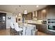 Modern kitchen with stainless steel appliances, granite countertops, large island, and stylish pendant lighting at 20 Wilcox St # 302, Castle Rock, CO 80104