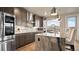 Kitchen with stainless steel appliances, custom cabinets, granite countertops, and eat in island with water view at 20 Wilcox St # 302, Castle Rock, CO 80104