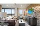 Cozy living room features a leather couch, brick accent wall, a decorative guitar, and a wall-mounted television at 20 Wilcox St # 302, Castle Rock, CO 80104