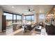 Spacious living room with floor-to-ceiling windows, a cozy leather couch, and stylish decor with ample natural light at 20 Wilcox St # 302, Castle Rock, CO 80104