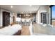 Open-concept living room with a modern kitchen, stylish bar stools, a comfortable sofa, and a rustic wooden dining table at 20 Wilcox St # 302, Castle Rock, CO 80104