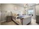 Well-lit main bedroom with plush bedding, neutral tones, and a view of the water at 20 Wilcox St # 302, Castle Rock, CO 80104