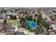 Aerial view of neighborhood park offering a playground, tennis courts, and lush greenery at 2353 S Jamaica St, Aurora, CO 80014