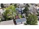 Aerial view of a home with lush backyard, mature trees, and a detached two-car garage at 2353 S Jamaica St, Aurora, CO 80014