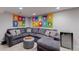 Basement living area features unique art installations and a large sectional sofa at 2353 S Jamaica St, Aurora, CO 80014