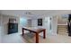 Finished basement area featuring a pool table, walkout and storage at 2353 S Jamaica St, Aurora, CO 80014