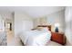 Cozy bedroom features neutral decor, ensuite bathroom and carpeted floors at 2353 S Jamaica St, Aurora, CO 80014