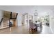Open-concept dining area with light wood floors, and seamless transition to stairs and outdoor access at 2353 S Jamaica St, Aurora, CO 80014