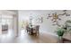 Elegant dining room featuring a stylish chandelier, contemporary artwork, and seamless kitchen access at 2353 S Jamaica St, Aurora, CO 80014