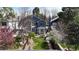 Charming home showcasing a well-manicured lawn, blossoming trees, and a lovely backyard space at 2353 S Jamaica St, Aurora, CO 80014