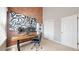 Home office with an exposed brick wall, natural light, and built-in storage at 2353 S Jamaica St, Aurora, CO 80014