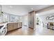 Open kitchen design with hardwood floors, stainless steel appliances, and access to dining area at 2353 S Jamaica St, Aurora, CO 80014