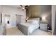 The main bedroom boasts an accent wall, ceiling fan, and sliding barn door entrance to a closet at 2353 S Jamaica St, Aurora, CO 80014