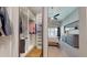Walk-in closet with built in storage and clothing racks that flows into the main bedroom at 2353 S Jamaica St, Aurora, CO 80014