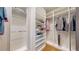Walk-in closet with built in storage and clothing racks at 2353 S Jamaica St, Aurora, CO 80014