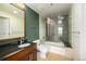 Clean bathroom with a tub, glass shower, and modern vanity at 891 14Th St # 3807, Denver, CO 80202