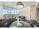 Modern dining area with glass table and city views at 891 14Th St # 3807, Denver, CO 80202