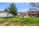 Expansive backyard showing a storage shed, well-maintained lawn, and pergola covered seating area at 6963 E Heritage S Pl, Centennial, CO 80111