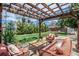Covered patio area with outdoor furniture, string lights, and lush landscaping at 6963 E Heritage S Pl, Centennial, CO 80111