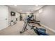 Bright carpeted basement with home gym equipment including a rowing machine, bench, and stationary bike at 6963 E Heritage S Pl, Centennial, CO 80111